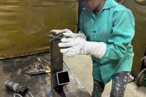 Girl Fitting Piece to Rocket Stove Girl Fitting Piece to Rocket Stove