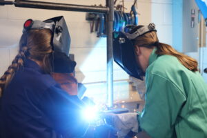Girls-in-Mnfg-2024-at-CLCS-Girls-Welding-Together-scaled Girls-in-Mnfg-2024-at-CLCS-Girls-Welding-Together-scaled